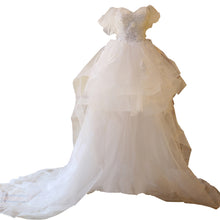 The Bride'S Wedding Dress With Long Tail In Front Of The Studio by Mirlaine Univers