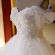 The Bride'S Wedding Dress With Long Tail In Front Of The Studio by Mirlaine Univers