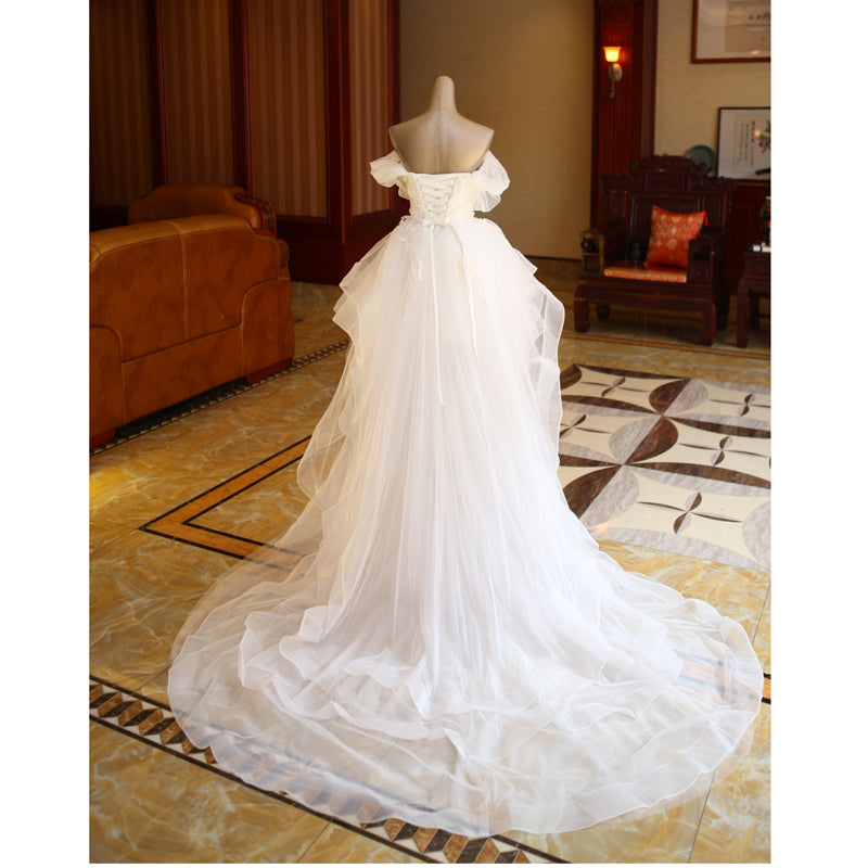 The Bride'S Wedding Dress With Long Tail In Front Of The Studio by Mirlaine Univers