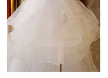 The Bride'S Wedding Dress With Long Tail In Front Of The Studio by Mirlaine Univers