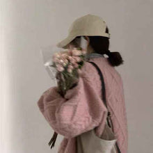 Women Wearing Loose Sweaters Outside The Street With Gentle Wind