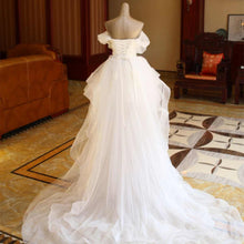 The Bride'S Wedding Dress With Long Tail In Front Of The Studio by Mirlaine Univers