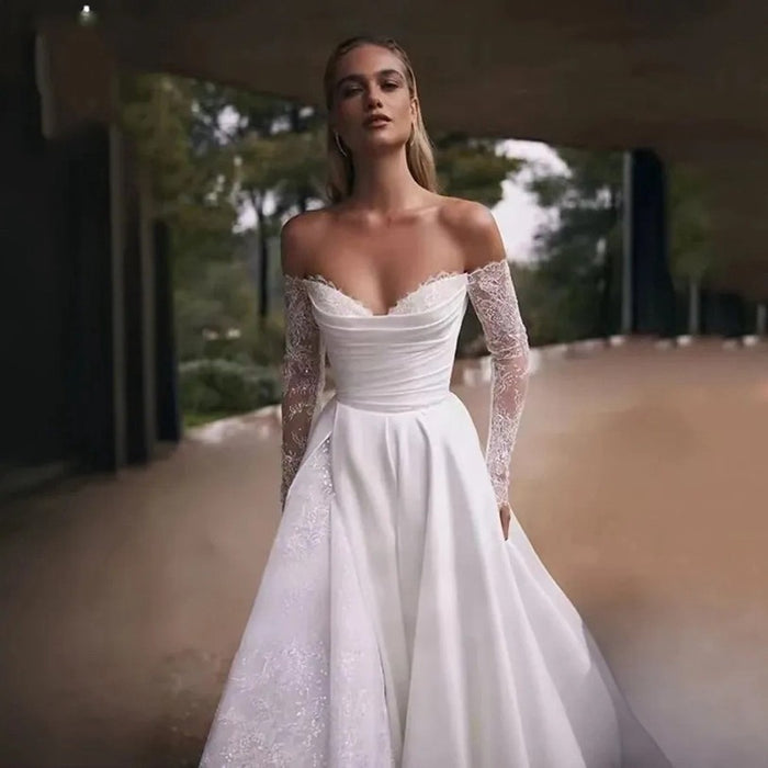 Robe de mariée élégante à manches longues et épaules dénudées avec traîne pour cérémonie et réception